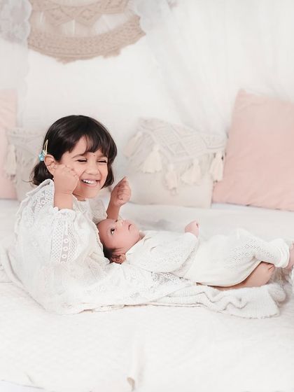 Capturing the laughter and playful moments between siblings is just as important as the quiet cuddles. This is pure, unfiltered joy.