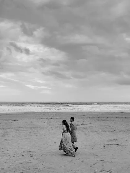 In the quiet moments after the chaos of Haldi, they walked along the shore. The world faded into soft grey tones, leaving only the sound of the waves and the feeling of their hands intertwined. This is the poetry I seek, the unscripted symphony of two people simply being together.
