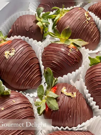 I believe in simple, pure indulgence. Here, perfectly ripe, succulent strawberries are hand-dipped in rich dark chocolate and finished with a delicate touch of 24-carat edible gold foil for a truly gourmet delight.