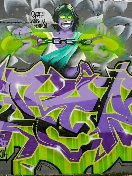 The full "Attitude Adjustment" piece, combining the character with a big, wildstyle graffiti piece. It's a fusion of humor, culture, and classic graff.