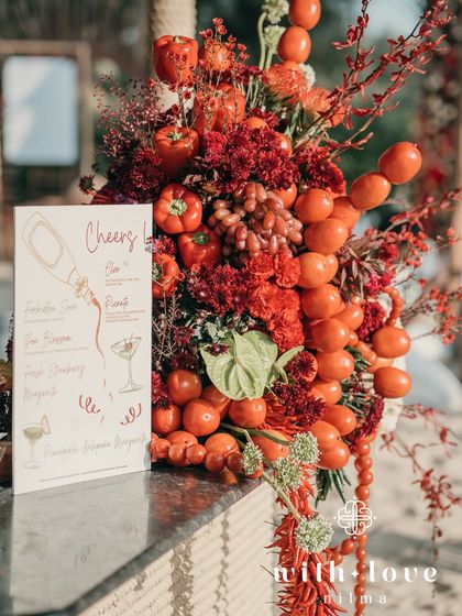 A close-up of the bar decor, with a custom cocktail menu and a vibrant arrangement of red fruits and vegetables.