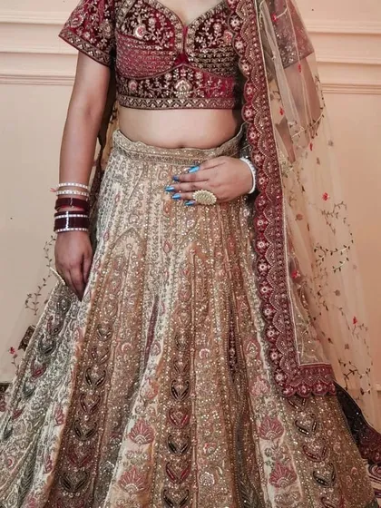 A closer look at the handwork on the Marwari bridal lehenga skirt. The intricate patterns and colours are a testament to traditional craftsmanship.
