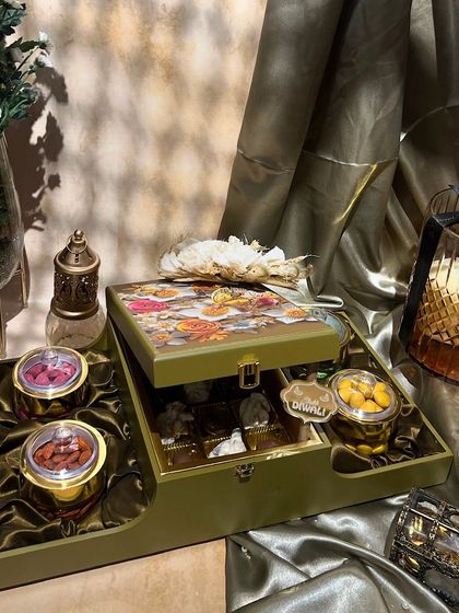 The olive green box opened to show the different compartments for sweets and dry fruits. A very organized and elegant presentation.