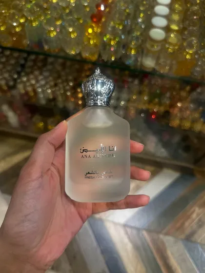 Holding a bottle of the popular Ana Abiyedh hair mist, a catch from a Dubai trip. These are the kind of exclusive items I can get for you when I travel.