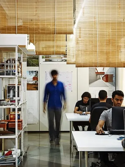 Another view of my design studio, showing the team at work. The open layout, natural light, and organized storage create an efficient and pleasant environment for the intense, detailed work of architecture.
