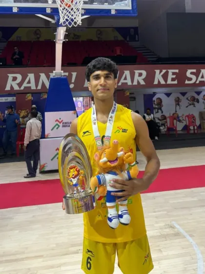 Another shot of my player with his trophy and mascot. He has inspired everyone around him, including me, to aim higher.