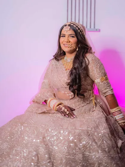 A close-up of Palak's radiant smile. Her makeup is designed to enhance her natural beauty and give her that signature bridal glow.