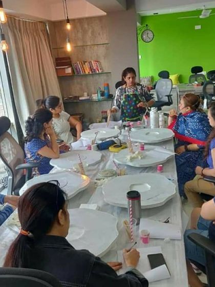 Here I am explaining the basics of resin pouring to a group of enthusiastic learners. My workshops are very hands-on, and I make sure everyone feels comfortable and supported throughout the process.