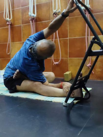 A seated side-stretch using a chair. This variation of Parivrtta Janu Sirsasana helps to open the side ribs and lengthen the spine.