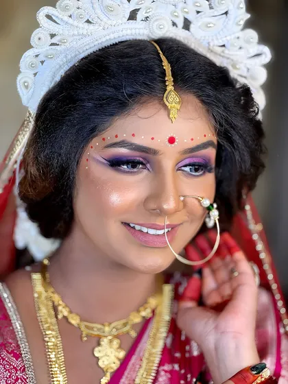 The traditional 'mukut' and radiant smile complete this beautiful Bengali bridal look. You'll learn how to create these culturally rich styles with authenticity.