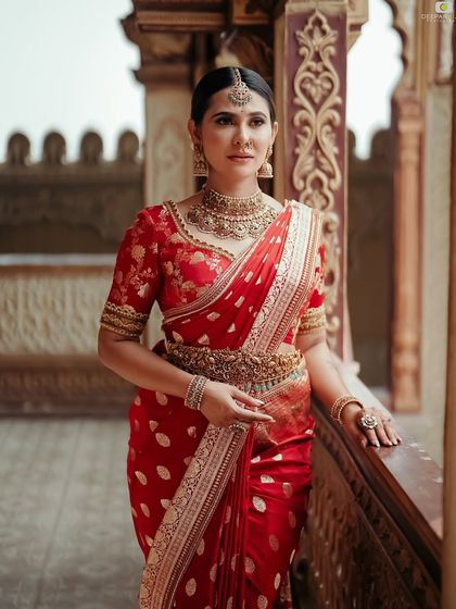 A portrait of me in a classic red Banarasi silk saree, paired with a matching embroidered blouse and traditional temple jewelry. This is a timeless look for any festive occasion.