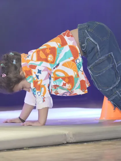 We incorporate foundational movements like crawling into our obstacle courses. This exercise helps develop a child's core stability and coordination, which are essential for both dance and overall physical literacy.