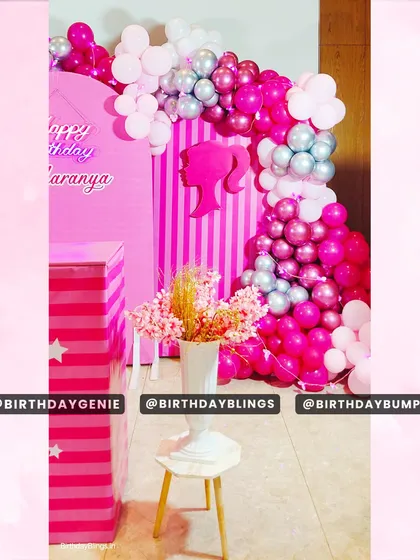 This view shows the beautiful balloon arch in shades of pink and silver, framing the entrance to the Barbie party area.