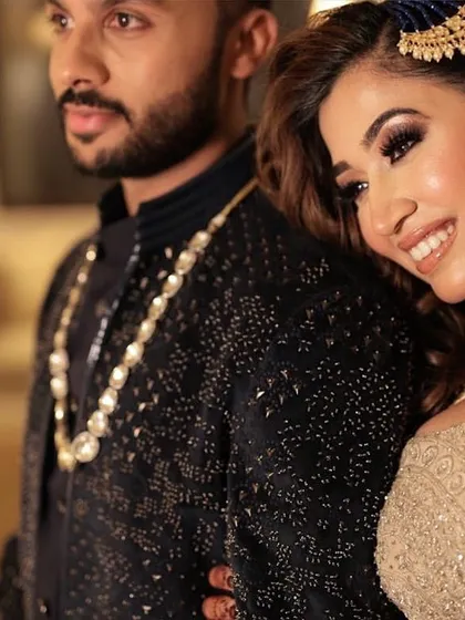 A close-up of the sangeet couple. You can see the beautiful details of her smokey eye makeup and the flawless finish of her skin.