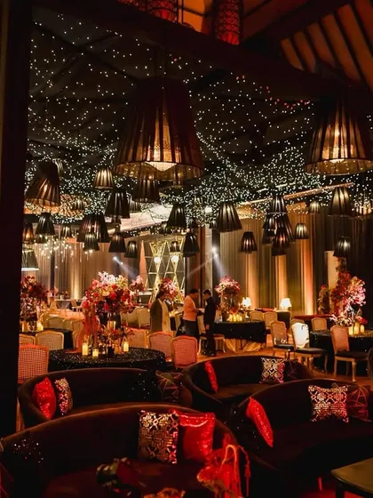 We create spaces that feel both grand and intimate. For this reception, we used heavy uplighting, lush floral centerpieces, and rich velvet seating to weave a tapestry of romance and radiant elegance.