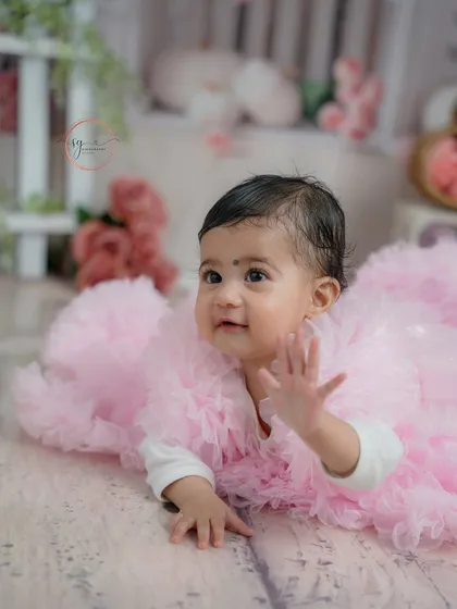 A sweet wave to the camera. I love capturing these interactive moments that show off a baby's developing personality.