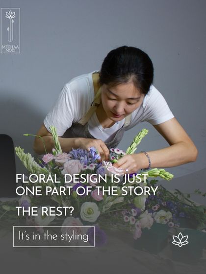 A student leans over her work, fully concentrated. This image captures the essence of my teaching: floral design is just one part of the story, the rest is in the styling and intention.