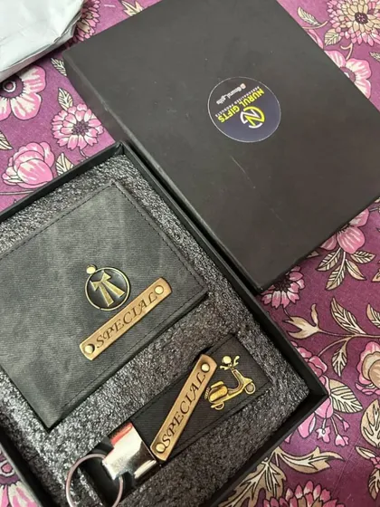 A personalized gift set in grey denim, this combo includes a wallet with a bow tie charm and a keychain with a scooter charm.