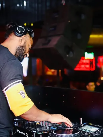 A side view of me working the mixer. This is where the magic happens, blending two tracks together to create a new energy.