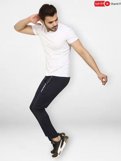 An action pose of a male model in athletic lowers and a t-shirt. This dynamic shot is perfect for sportswear brands looking to convey movement and performance.