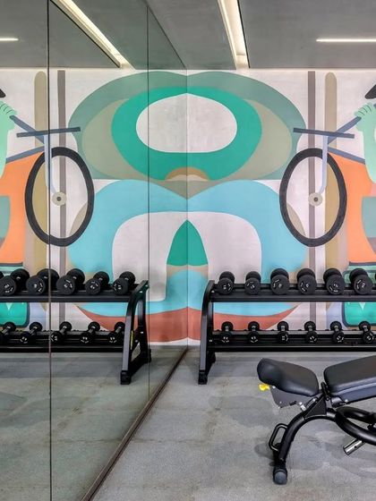 A mirrored reflection of the gym mural, creating a symmetrical and powerful visual effect in the weightlifting area.