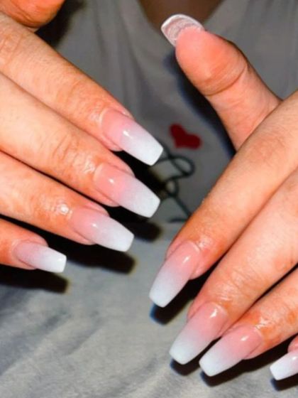 A classic and clean set of long, coffin-shaped nails with a white and pink ombre.