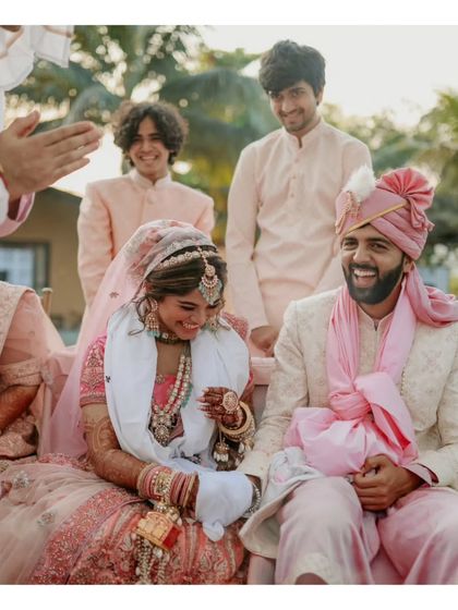A candid moment of laughter and joy shared by the couple and their friends during the wedding ceremony.