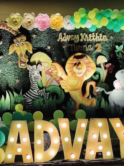 A highly detailed and dimensional jungle backdrop for Advay's second birthday, featuring 3D-style cutouts of various animals to create a lively forest scene.