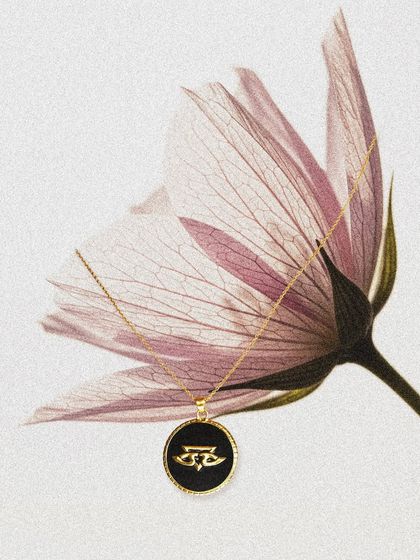 An artistic representation of the Chevron Pendant, showcasing its delicate chain and striking design. A perfect gift for someone who appreciates timeless style.