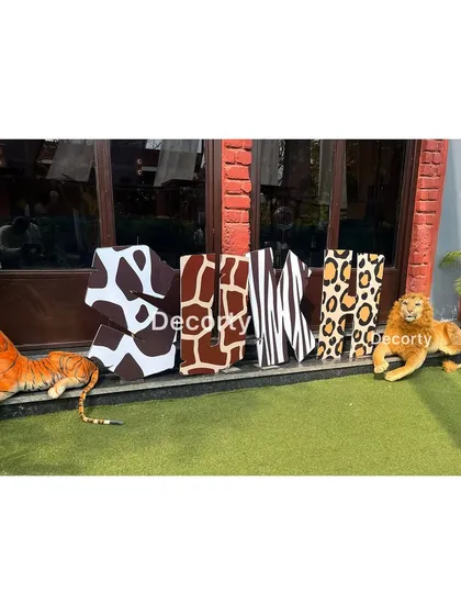 Custom letters spelling "SUKH" in various animal prints, a great personalized detail.