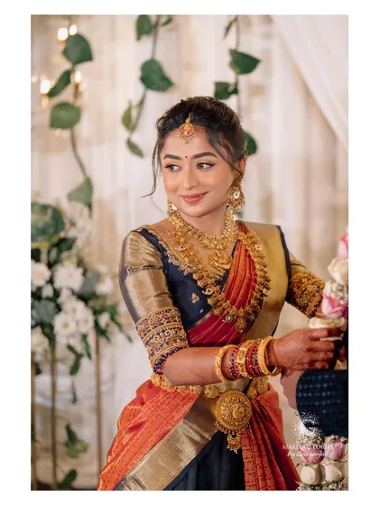 The beautiful Harshitha for her engagement, embodying traditional South Indian grace. The makeup is soft and radiant, enhancing her features while complementing the richness of her silk saree and gold jewelry, a popular choice for Bangalore brides.