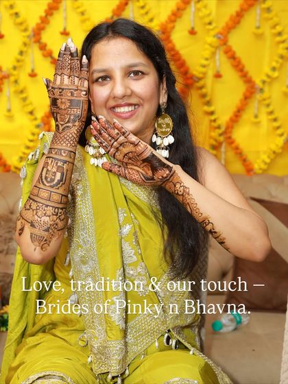 Love, tradition, and our touch. A smiling bride proudly displays both her hands, covered in our intricate artwork.
