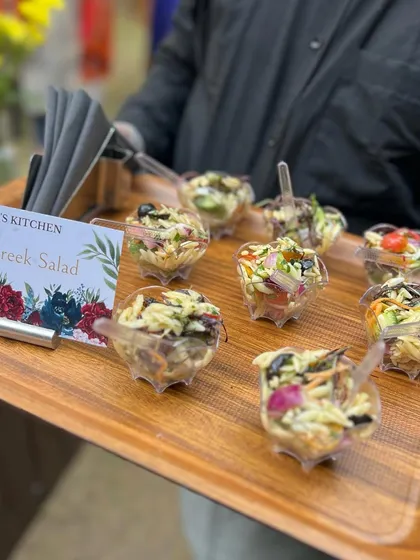 Fresh and healthy Orzo Greek Salad served in individual cups, a perfect light and zesty option for any buffet.