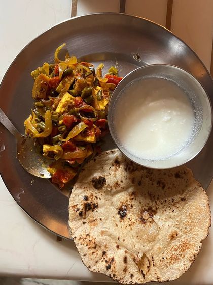 A balanced thali with paneer stir-fry, roti, and curd. This is a typical lunch for a client on a 20-day weight loss plan.