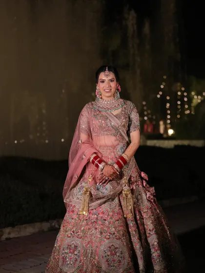 A full-length shot of Muskaan looking absolutely breathtaking. Her pastel lehenga and soft makeup are perfect for a modern wedding, creating a look that is both timeless and fresh.