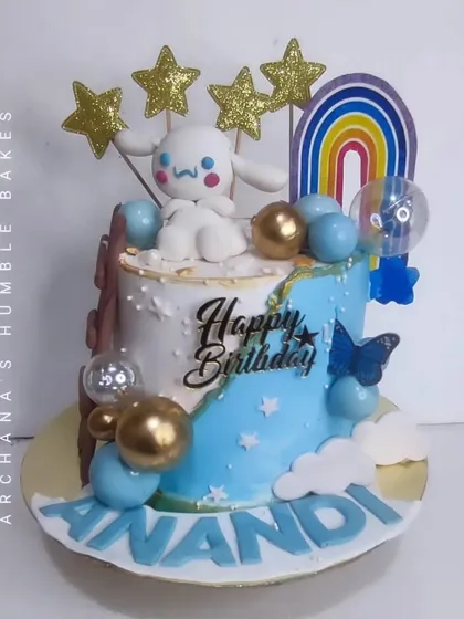 A Cinnamoroll cake decorated with stars, a rainbow, and balloons for Anandi's birthday.