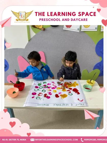 A wider view of the fruit and vegetable printing station. This setup encourages children to experiment with different items and colors, fostering scientific thinking and creativity.