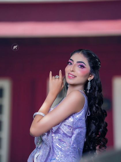 A fun and edgy pose that matches the energy of the makeup.