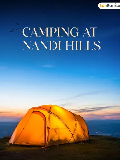 A tent glowing against the twilight sky at Nandi Hills. This is the perfect quick escape for adventure and tranquility.