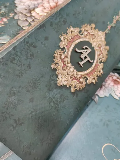 Personalization is key to making an invitation feel special. Here, I've used custom-cut MDF initials with a glitter finish, set against a deep emerald green floral design. This shows how a small detail can elevate the entire look.