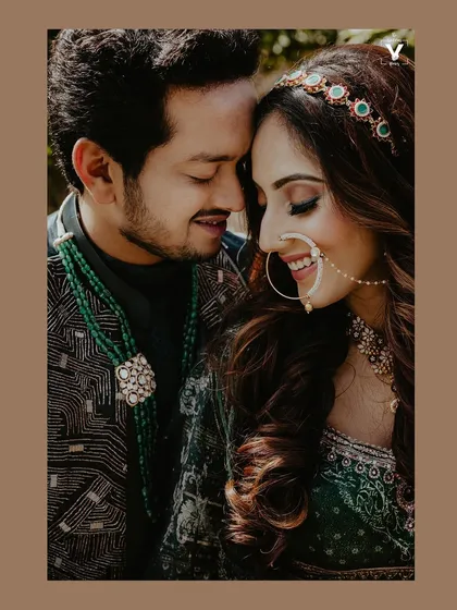 A close-up portrait filled with warmth and genuine smiles. The bride's nath and the groom's loving gaze create a beautiful, intimate moment during their Udaipur wedding.
