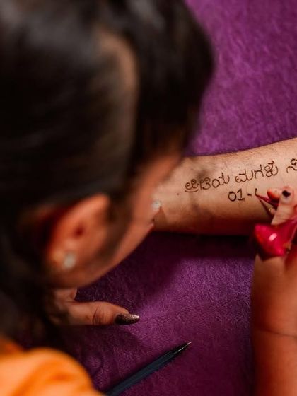 A close-up of a father getting a henna tattoo for his daughter's wedding. A testament to a father's love.