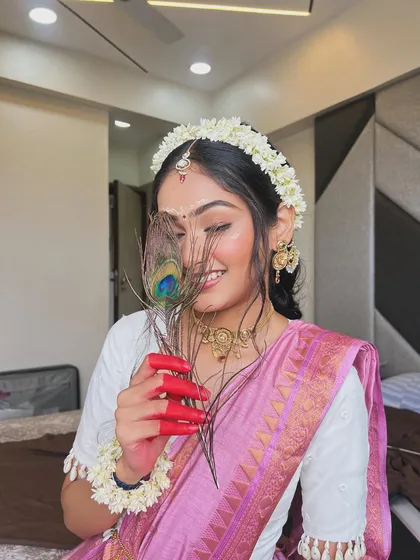 A candid, smiling shot that captures the essence of this devotional and beautiful Janmashtami look.