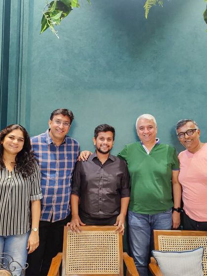 Our founder Ujjwal with a client and his family during a consultation. Creating the perfect bespoke outfit is a team effort.