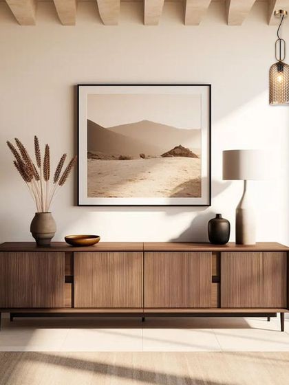 A pair of mesh cage pendants flank a piece of art, creating a sense of symmetry and calm. These lights shine with style and make this home feel truly special.