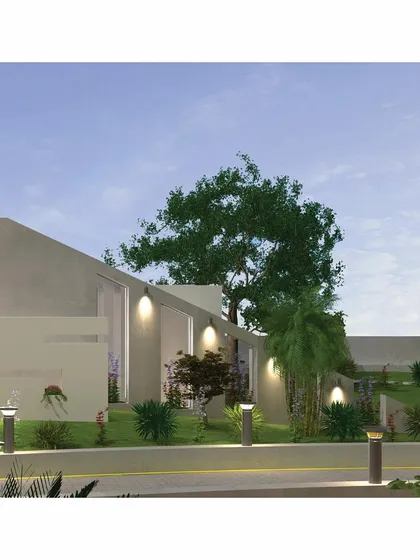 The memorial's tapered form is clearly visible in this view, symbolizing a life of strength and stability. The structure is surrounded by dense landscaping, creating a private sanctuary that feels separate from the outside world.