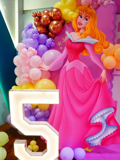 A close-up of the Sleeping Beauty cutout and the illuminated number '5'. We use high-quality props and lighting to make our decor stand out.