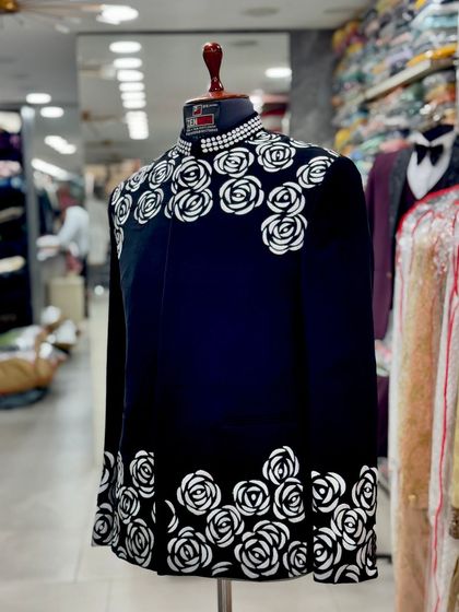 A side view of the black and white rose Jodhpuri, showing how the pattern wraps around the jacket.