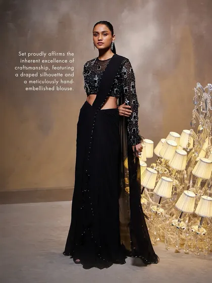 The Diana Saree Set proudly affirms its craftsmanship with a draped silhouette and a meticulously hand-embellished blouse, perfect for a formal evening.