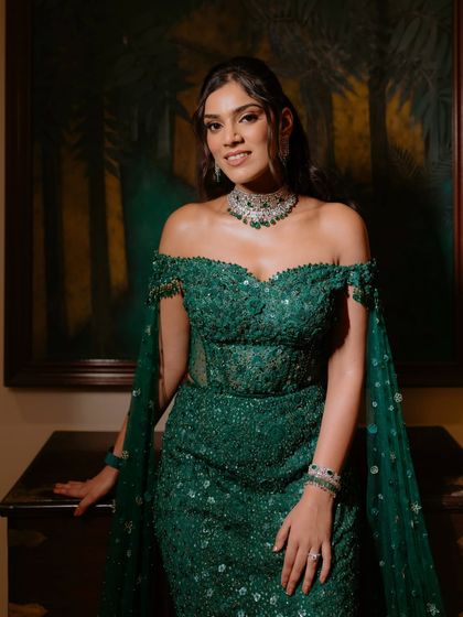 The bride looking absolutely stunning and confident. The makeup enhances her features beautifully, ensuring she is the star of her reception night.